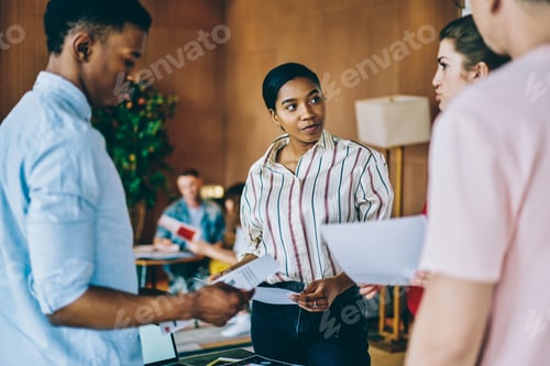 Preview: Confident woman with paper interacting with business group