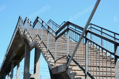Preview: A fragment of a stepped ascent to the pedestrian bridge between the platforms of the railway