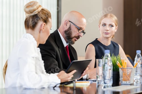 Preview: Business meeting with professionals discussing strategy in a modern office setting