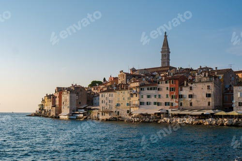 Preview: Golden sunset casts a warm glow over historic Rovinj's colorful shoreline and serene waters