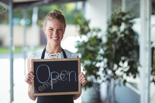 Preview: Portrait Of Waitress Standing With Chalkboard Outside The Cafe