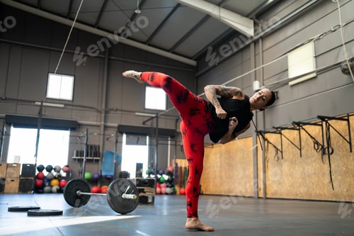 Preview: Woman throwing a kick in the air in the gym