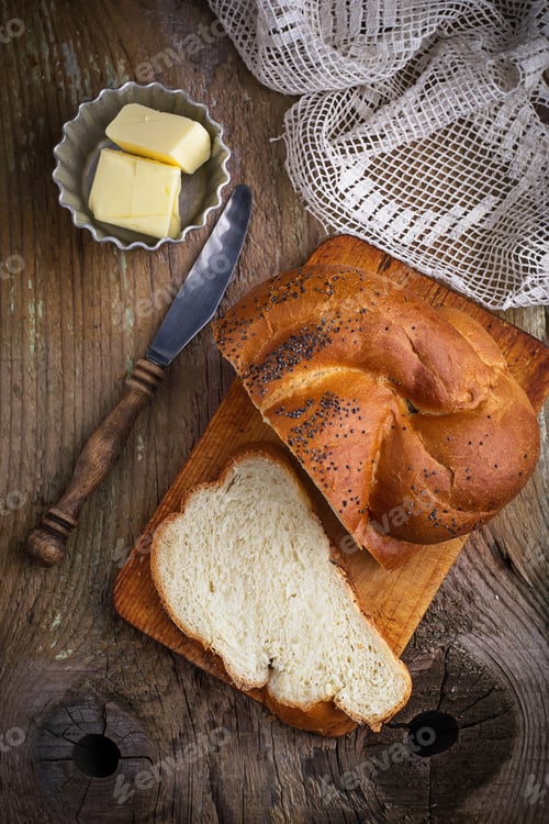 Preview: Homemade bread with butter on wooden background