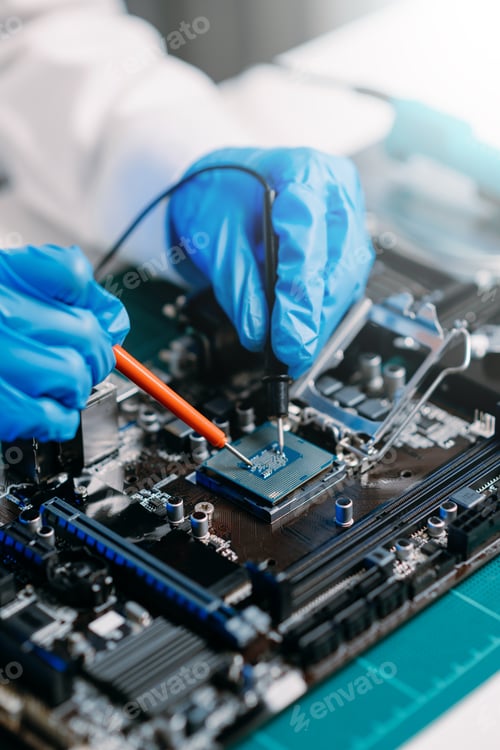 Preview: The technician is putting the CPU on the socket of the computer motherboard.