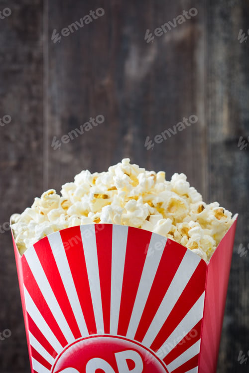 Preview: Classic red and white striped popcorn box overflowing with buttery popcorn