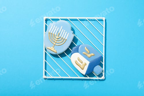 Preview: Gingerbread cookies with Jewish symbols on blue background, top view