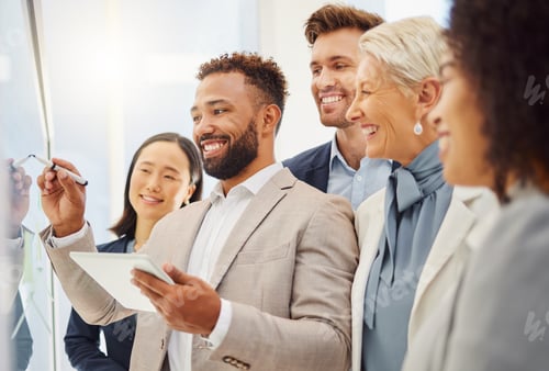 Preview: Young mixed race businessman using a digital tablet while leading his diverse team by explaining pr