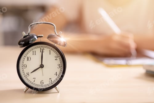 Preview: Education alarm times clock School student learning study writing at the morning blur background.