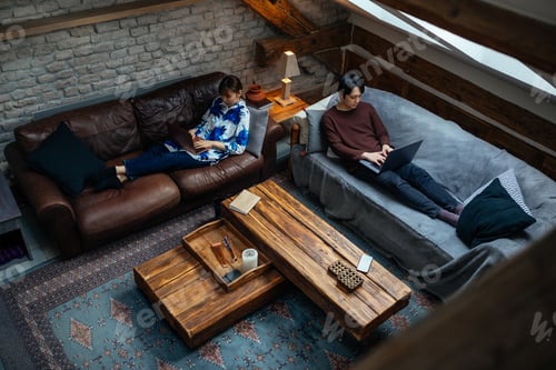 Preview: Japanese man and woman lying on beds and using technology