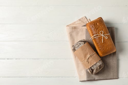Preview: Flat lay composition with bakery products on wooden background, top view and space for text