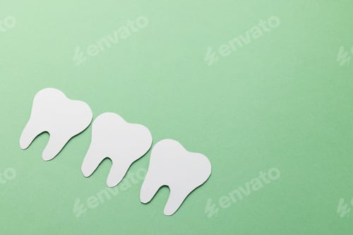 Preview: Composition of white teeth on green background with copy space