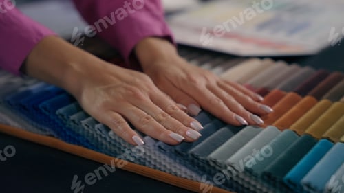 Preview: Close up hands woman girl touch soft fabric samples choose select cloth colorful palette design