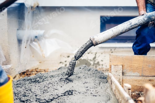 Preview: industrial workers pouring cement with manual pump tube