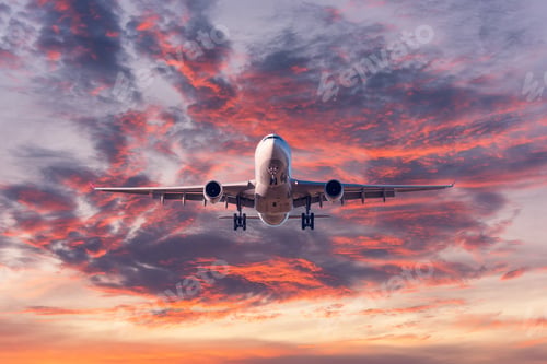 Preview: Landing passenger airplane at colorful sunset
