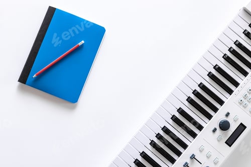 Preview: Musical keys and notepad on white background, flat lay.