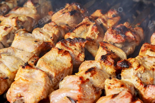 Preview: raw kebab grilling on metal skewer