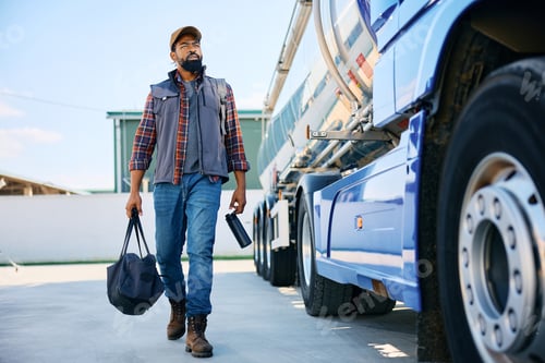 Preview: Professional black truck driver coming to work