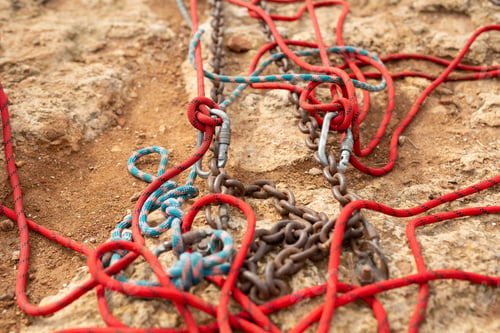 Preview: Equipment for rock climbing and ropejumping: carabiners and ropes on the rock close-up.