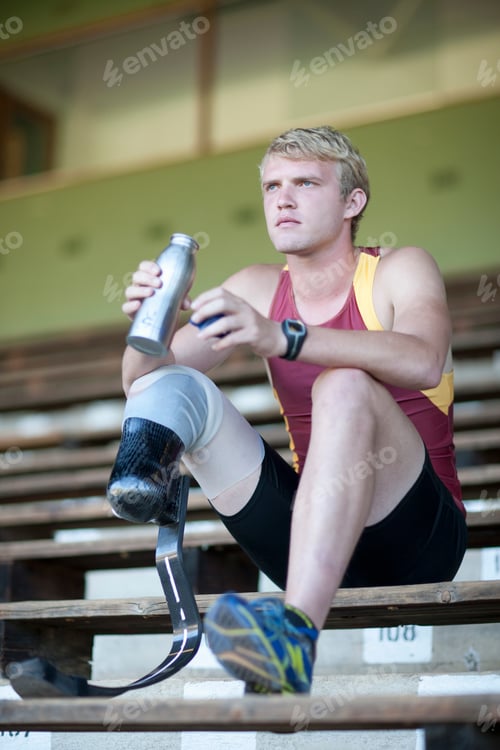 Preview: Sprinter sitting with prosthetic leg on