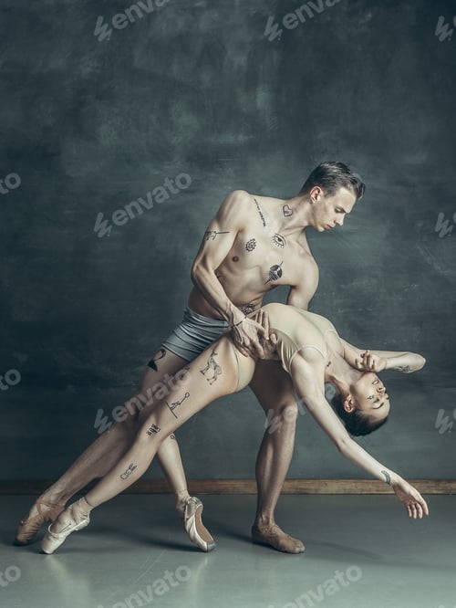 Preview: The young modern ballet dancers posing on gray studio background