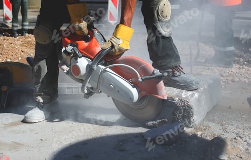 Preview: Builder worker with cut-off machine power tool breaking concrete at road construction site