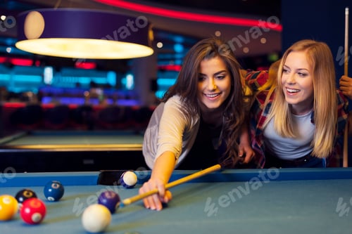 Preview: Two female friends enjoying pool game