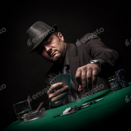 Preview: Studio shot of male gambler playing poker isolated on black background.
