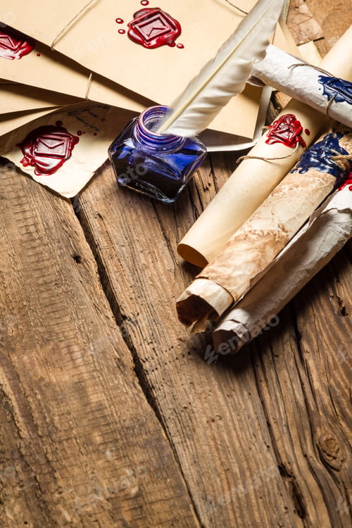 Preview: Old rolls of paper and blue ink in the inkwell as vintage background