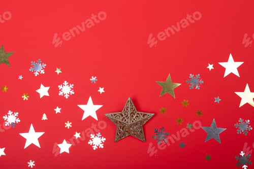 Preview: Composition of christmas decorations with stars, snowflakes and copy space on red background