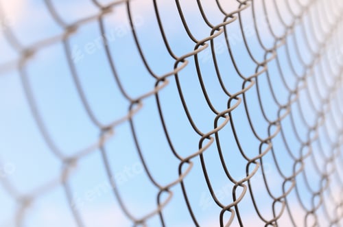 Preview: A photograph of a metal net used as a fence of private possessions. Old metal grid in