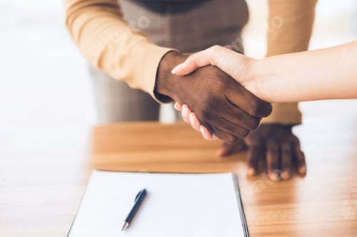 Preview: Successful business people shaking hands closing deal
