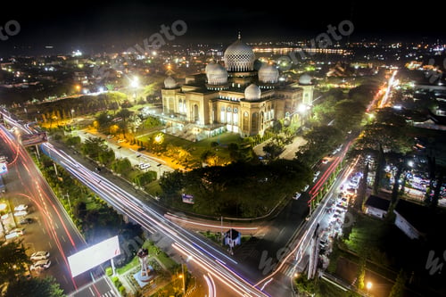 Preview: Beautiful Islamic Center Mosque in Lhokseumawe, Aceh, Indonesia. Aerial view of cityscape at night.