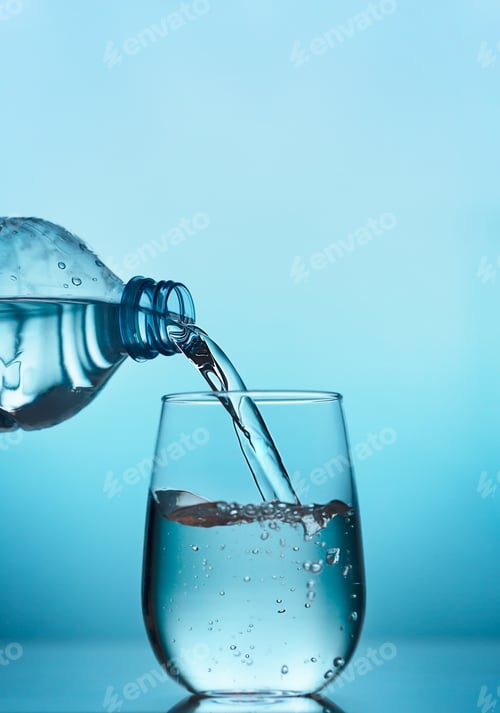 Preview: Fresh water pouring into a glass on the blue background
