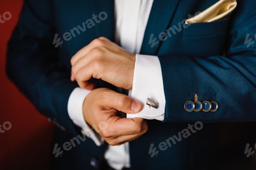 Preview: Man's hands buttoning cufflinks on white shirt. Groom's elegant male gold cufflink. wedding