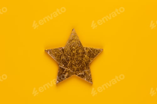 Preview: Christmas star decor on yellow colored background.