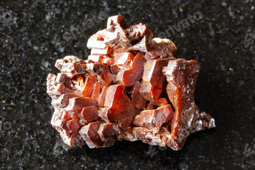 Preview: sample of raw vanadinite mineral on black granite
