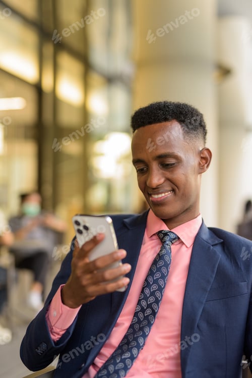 Preview: Portrait of successful young African businessman wearing suit and tie