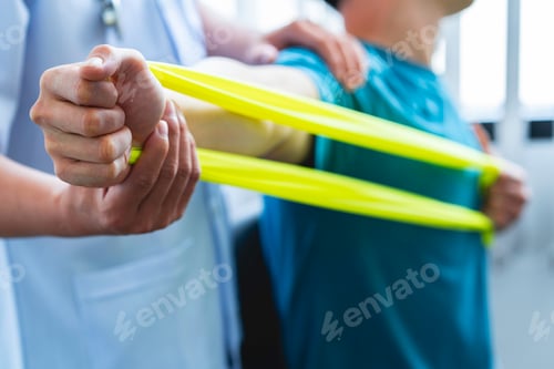 Preview: Physical therapist gives resistance band exercises. About the arms and shoulders of male office work