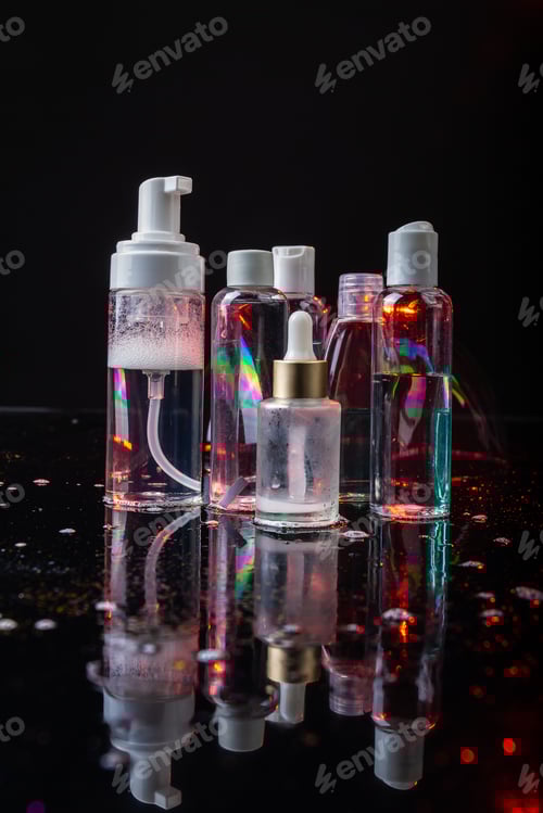 Preview: Set of cosmetic bottles on dark background.
