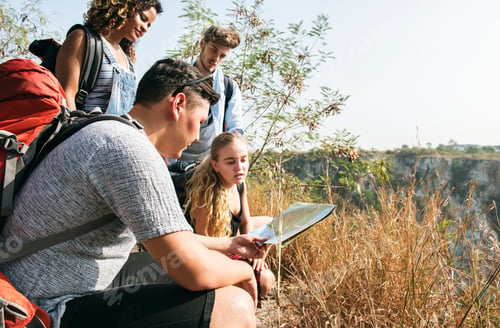 Preview: Hiker friends looking at a map together