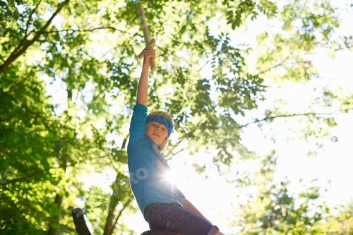 Preview: One young boy with toy sword, sitting on tree branch