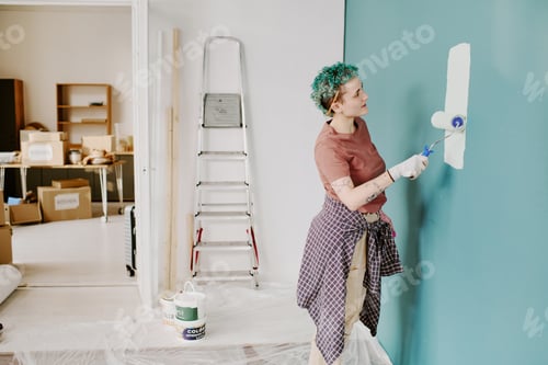 Preview: Woman Painting Wall While Moving into New Home Renovation