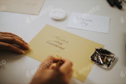 Preview: Never stop learning, calligraphy. Close-up image of woman writing cali