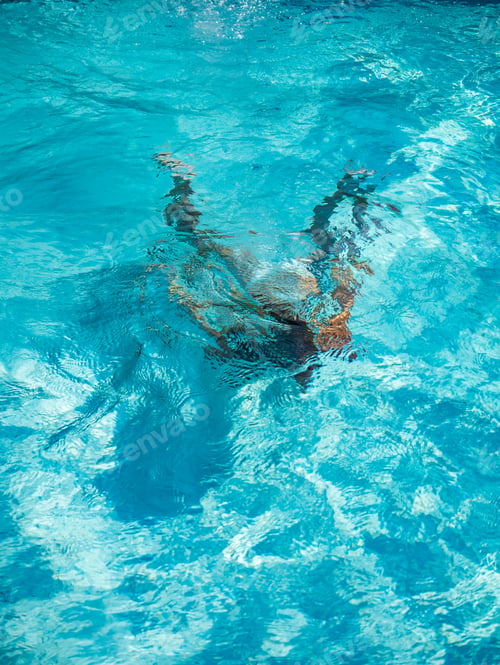 Preview: girl diving in the swimming pool