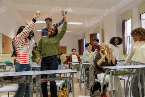 Preview: Happy diverse students celebrating academic success in classroom