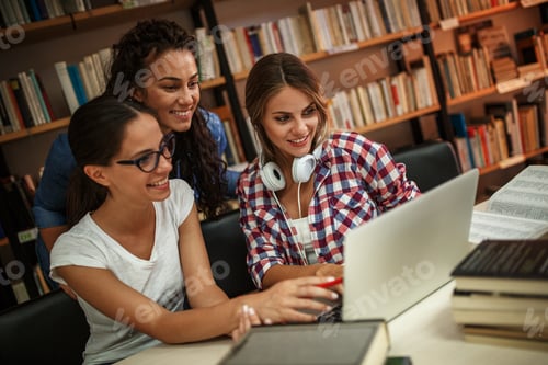 Preview: Group of female students study in the college library.