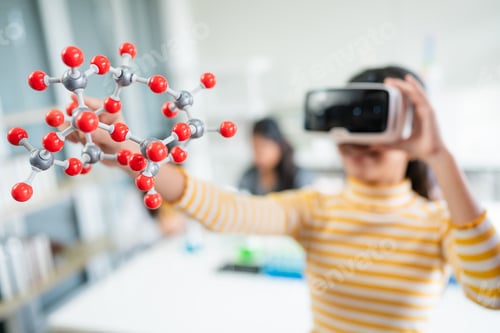 Preview: Girl having fun time with holding molecular model learning.
