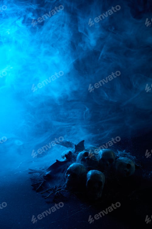 Preview: Halloween human skulls in abstract smoke on black background.