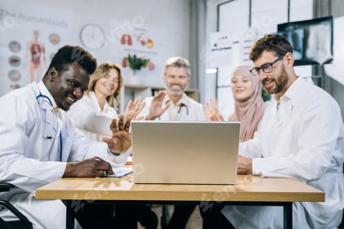 Preview: Qualified diverse doctors using laptop for video call