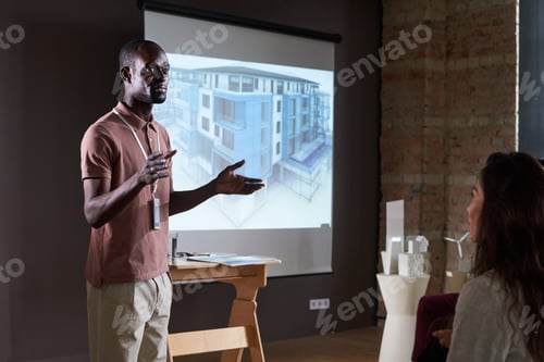 Preview: Businessman presenting blueprint at conference